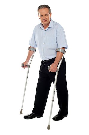 simsearch:400-07987656,k - Old handicapped man with a walker  standing against white background Stock Photo - Budget Royalty-Free & Subscription, Code: 400-07987654