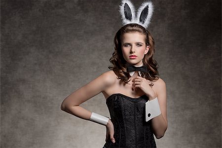 simsearch:400-07254895,k - very brunette girl wearing like playgirl with fluffy bunny ears, black papillon and corset posing in glamour easter shoot Stock Photo - Budget Royalty-Free & Subscription, Code: 400-07987869