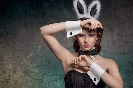 simsearch:400-07254895,k - sexy brunette pinup girl with fluffy bunny ears, papillon and dark corset posing in easter glamour portrait Stock Photo - Budget Royalty-Free & Subscription, Code: 400-07987871