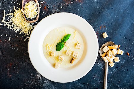 onion soup puree in a white plate with toasts and cheese on the black table Stock Photo - Budget Royalty-Free & Subscription, Code: 400-07988088