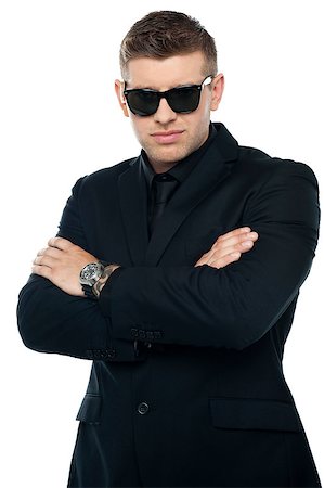 Young stylish bouncer in a black suit, arms folded. Half length portrait Stock Photo - Budget Royalty-Free & Subscription, Code: 400-07988509