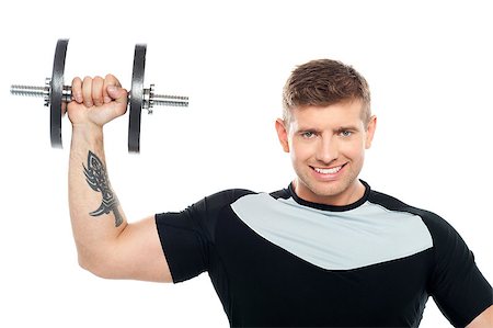 simsearch:400-06859184,k - Half length portrait of young male instructor posing with raised dumbbell Photographie de stock - Aubaine LD & Abonnement, Code: 400-07988604