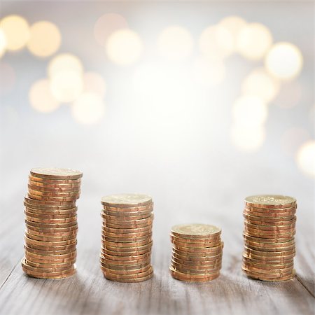 Coins stack in row on wooden background, financial concept. Focus on foreground with blur shinny background. Stock Photo - Budget Royalty-Free & Subscription, Code: 400-07989909