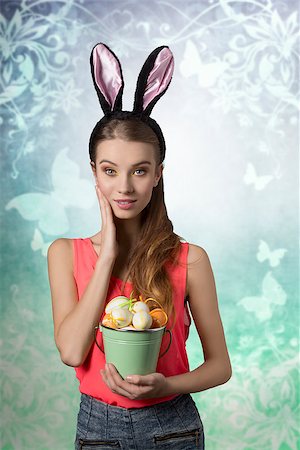 Pretty, easter girl with rabbit, fluffy ears and bucket of easter eggs. She wears to and jeans shorts. She has got nice make up. Stock Photo - Budget Royalty-Free & Subscription, Code: 400-07989924