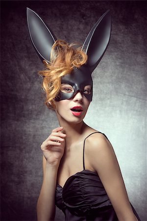 simsearch:400-07254895,k - Beautiful, sexy, charming woman in carnival, black costume of bunny, with wild hairstyle and red lips. Stock Photo - Budget Royalty-Free & Subscription, Code: 400-07981357
