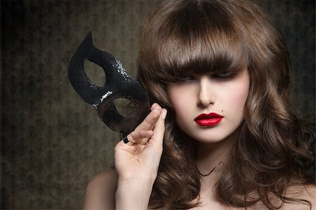 simsearch:400-07981805,k - close-up portrait of charming brunette female with elegant hair-style and mysterious expression psing with black mask in the hand Stock Photo - Budget Royalty-Free & Subscription, Code: 400-07981648
