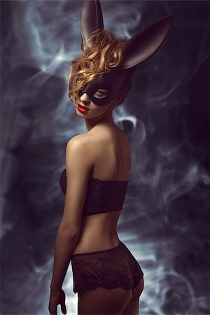 simsearch:400-07981805,k - curly woman posing in Easter fashion glamour shoot with black bizarre bunny mask and stylish lace lingerie Stock Photo - Budget Royalty-Free & Subscription, Code: 400-07983421