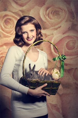 simsearch:400-08036285,k - Beautiful, sweet, brunette woman is holding easter basket with little, cute, fluffy rabbit and an egg. Stockbilder - Microstock & Abonnement, Bildnummer: 400-07983481