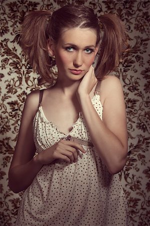 simsearch:400-04895941,k - Charming, natural, fresh woman with cute ponytails wearing beige pijamas and looking at camera. Fotografie stock - Microstock e Abbonamento, Codice: 400-07983769