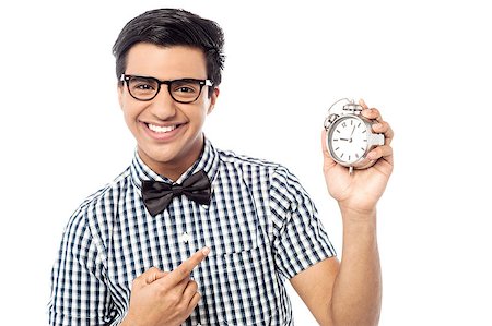 Young man showing a alarm clock, time concept Stock Photo - Budget Royalty-Free & Subscription, Code: 400-07983948