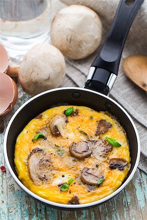 fried egg and pepper - Homemade omelette with mushrooms in a pan Stock Photo - Budget Royalty-Free & Subscription, Code: 400-07994037