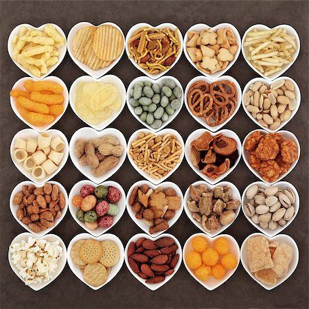 simsearch:400-07993733,k - Savoury snack food selection in heart shaped porcelain dishes. Photographie de stock - Aubaine LD & Abonnement, Code: 400-07994109