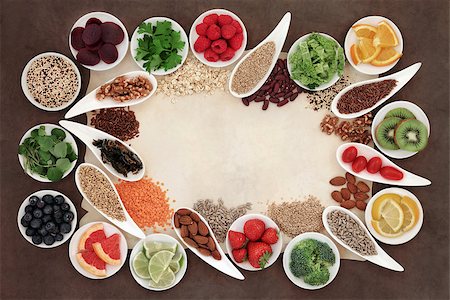 simsearch:400-08429907,k - Diet detox superfood selection in porcelain bowls over parchment paper and brown background. Fotografie stock - Microstock e Abbonamento, Codice: 400-07994510