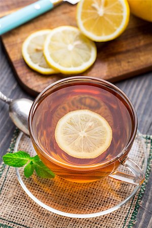 simsearch:400-06554630,k - Cup of tea with mint and lemon on wooden table Stock Photo - Budget Royalty-Free & Subscription, Code: 400-07994660