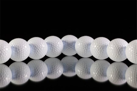 simsearch:400-07218310,k - Golf balls on the black glass table Photographie de stock - Aubaine LD & Abonnement, Code: 400-07994923