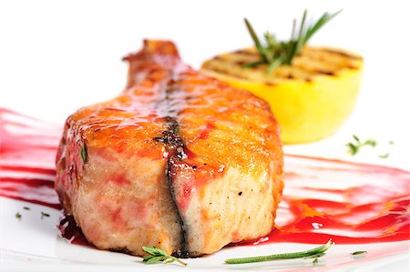 Grilled salmon steak with red sauce, lemon and rosemary, on white Stock Photo - Budget Royalty-Free & Subscription, Code: 400-07994996