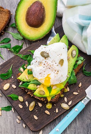 sandwich with avocado - Avocado sandwich with arugula, seeds and poached egg Stock Photo - Budget Royalty-Free & Subscription, Code: 400-07995235