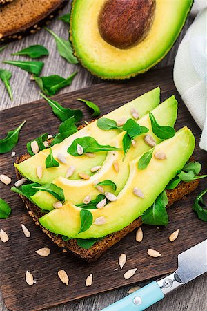 sandwich with avocado - Avocado sandwich with arugula and sunflower seeds Stock Photo - Budget Royalty-Free & Subscription, Code: 400-07995243