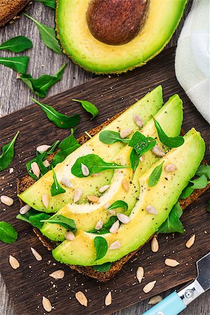 sandwich with avocado - Avocado sandwich with arugula and sunflower seeds Stock Photo - Budget Royalty-Free & Subscription, Code: 400-07995552