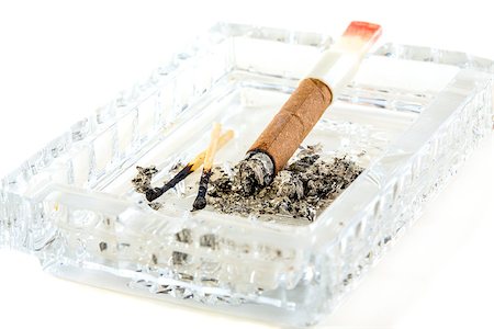 simsearch:400-05292494,k - Cigarette butt with red lipstick in the ashtray on a white background. Foto de stock - Super Valor sin royalties y Suscripción, Código: 400-07995673