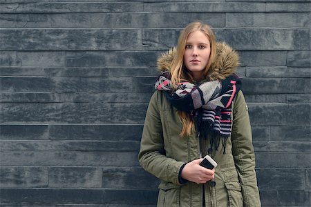 Fashionable Young Woman in Winter Outfit Posing in Front Old Gray Wall while Looking at the Camera. Fotografie stock - Microstock e Abbonamento, Codice: 400-07996165