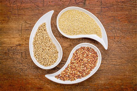 sorghum, millet and buckwheat - three gluten free grains in teardrop shaped bowls against rustic wood Stock Photo - Budget Royalty-Free & Subscription, Code: 400-07996448