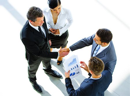 Top view of a two businessman shaking hands - Welcome to business Stock Photo - Budget Royalty-Free & Subscription, Code: 400-07996733