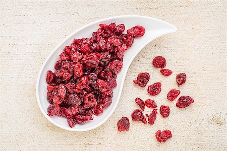 simsearch:400-08334670,k - dried cranberry on a teardrop shaped bowl against a rustic barn wood Stock Photo - Budget Royalty-Free & Subscription, Code: 400-07996807