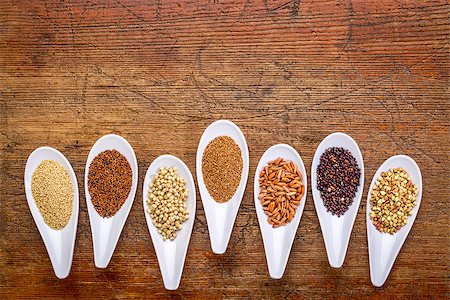 simsearch:400-08253307,k - seven healthy, gluten free grains (quinoa, brown rice, amaranth, teff, buckwheat, sorghum. kaniwa), top view of small spoons against rustic wood with a copy space Stock Photo - Budget Royalty-Free & Subscription, Code: 400-07997252