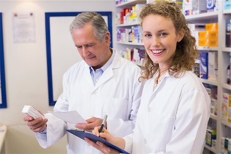 Pharmacist looking a medication for a prescription in the pharmacy Stock Photo - Budget Royalty-Free & Subscription, Code: 400-07990532