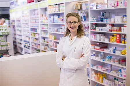 Portrait of a smiling pharmacist in lab coat with arms crossed in the pharmacy Stock Photo - Budget Royalty-Free & Subscription, Code: 400-07990581