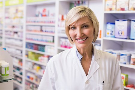 Pharmacist smiling at camera at pharmacy Stock Photo - Budget Royalty-Free & Subscription, Code: 400-07990599