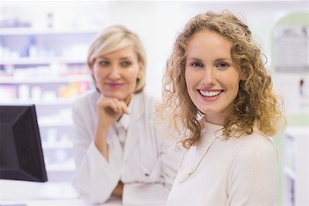 Pharmacist and costumer smiling at camera at pharmacy Stock Photo - Budget Royalty-Free & Subscription, Code: 400-07990650