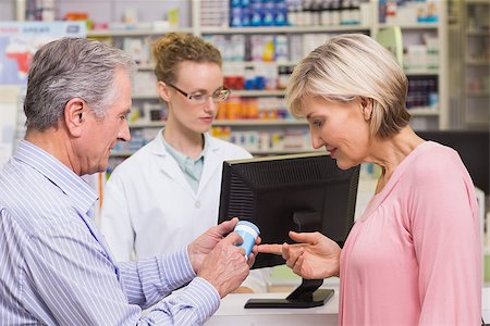 pharmacist with senior - Costumers talking about medicine at pharmacy Stock Photo - Budget Royalty-Free & Subscription, Code: 400-07990674