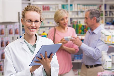 Pharmacist using tablet pc at the pharmacy Stock Photo - Budget Royalty-Free & Subscription, Code: 400-07990678