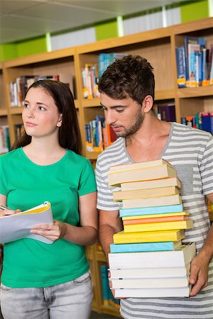 Students with pile of books in the library at the university Stock Photo - Budget Royalty-Free & Subscription, Code: 400-07990840