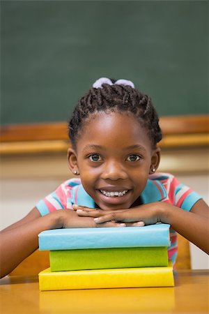 simsearch:400-07991069,k - Smiling pupil sitting at her desk at the elementary school Foto de stock - Royalty-Free Super Valor e Assinatura, Número: 400-07990985