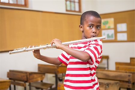 simsearch:400-07991069,k - Cute pupil playing flute in classroom at the elementary school Foto de stock - Royalty-Free Super Valor e Assinatura, Número: 400-07991064