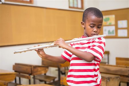 simsearch:400-07991069,k - Cute pupil playing flute in classroom at the elementary school Foto de stock - Royalty-Free Super Valor e Assinatura, Número: 400-07991065