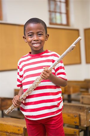 simsearch:400-07991069,k - Happy pupil holding flute at elementary school Foto de stock - Royalty-Free Super Valor e Assinatura, Número: 400-07991066