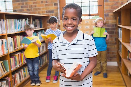 simsearch:400-07991158,k - Pupil smiling at camera at library at elementary school Stock Photo - Budget Royalty-Free & Subscription, Code: 400-07991106
