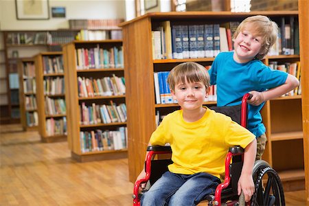 Cute pupils smiling at camera at the library at elementary school Stock Photo - Budget Royalty-Free & Subscription, Code: 400-07991102