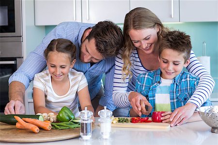 simsearch:400-06930138,k - Happy family preparing vegetables together at home in the kitchen Stock Photo - Budget Royalty-Free & Subscription, Code: 400-07991354