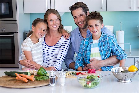 simsearch:400-06930138,k - Happy family preparing vegetables together at home in the kitchen Stock Photo - Budget Royalty-Free & Subscription, Code: 400-07991355