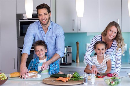 simsearch:400-06930138,k - Happy family preparing vegetables together at home in the kitchen Stock Photo - Budget Royalty-Free & Subscription, Code: 400-07991357