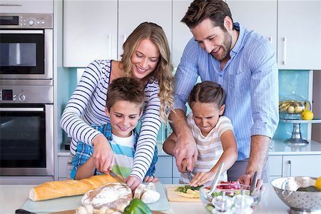 simsearch:400-06930138,k - Happy family preparing vegetables together at home in the kitchen Stock Photo - Budget Royalty-Free & Subscription, Code: 400-07991358