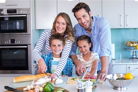 simsearch:400-06930138,k - Happy family preparing vegetables together at home in the kitchen Stock Photo - Budget Royalty-Free & Subscription, Code: 400-07991359