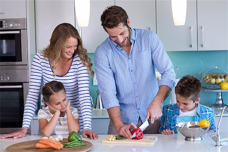 simsearch:400-06930138,k - Happy family preparing vegetables together at home in the kitchen Stock Photo - Budget Royalty-Free & Subscription, Code: 400-07991352