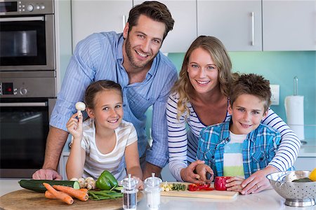 simsearch:400-06930138,k - Happy family preparing vegetables together at home in the kitchen Stock Photo - Budget Royalty-Free & Subscription, Code: 400-07991353