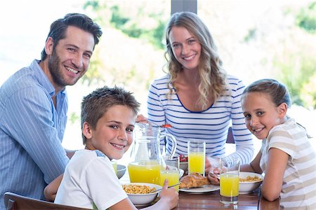 simsearch:400-06930138,k - Happy family having breakfast together in the morning at home in the kitchen Stock Photo - Budget Royalty-Free & Subscription, Code: 400-07991380